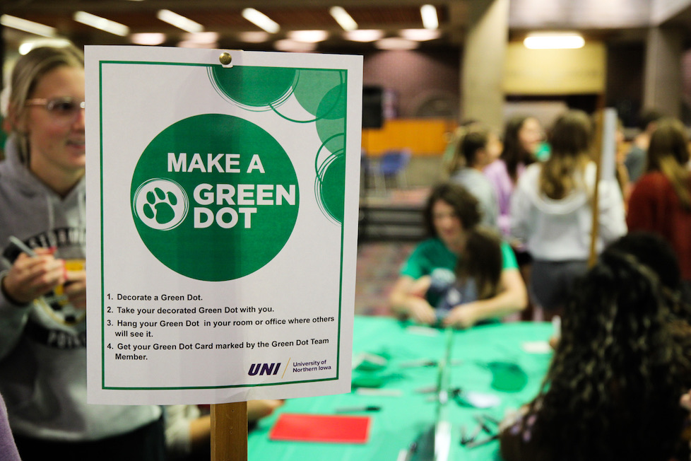 A sign that says "Make a Green Dot" with instructions on how to make one at an event. 